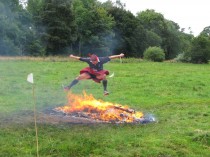 Francis Ogilvy jumping over Spartan bonfire.