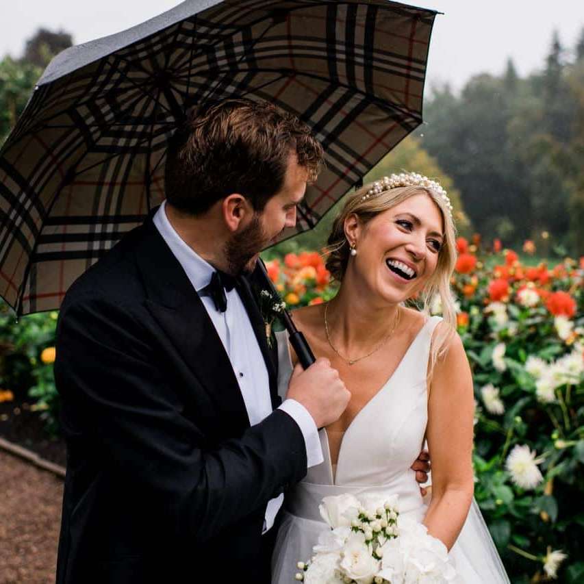 Bride and Groom in the rain on Terraced Gardens Winton Castle near Edinburgh