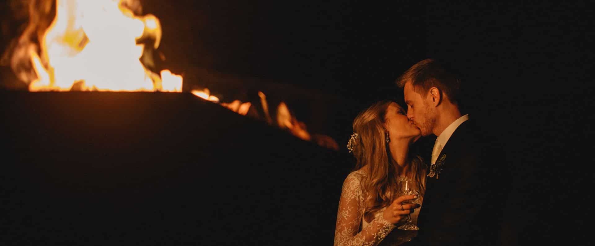 Wedding couple by fire pit - Autumn & Winter Weddings - Winton Castle