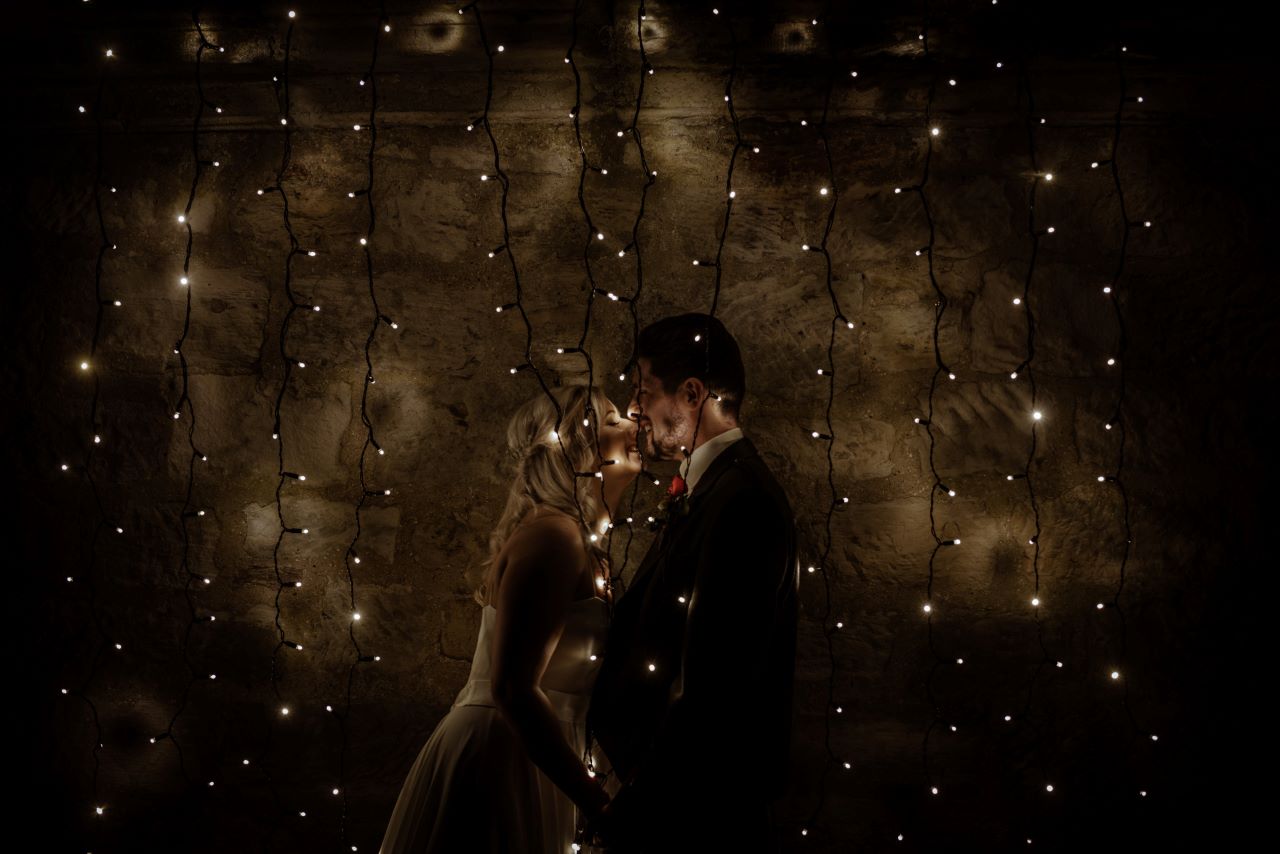 Bride and Groom through the fairy lights