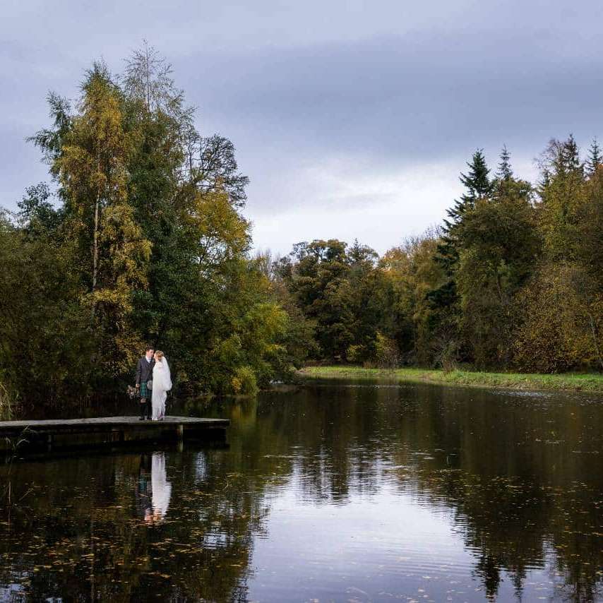 Bride and Groom on the Pier - Autumn Weddings Winton Castle